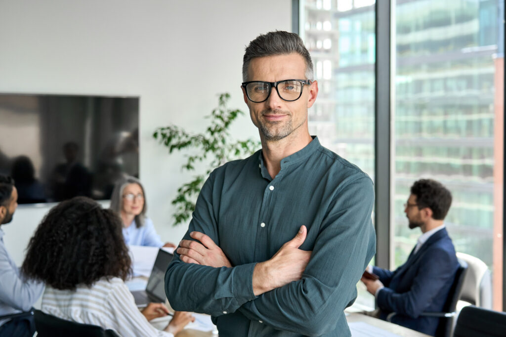 Smiling Confident Mature Businessman Leader Looking At Camera Standing In